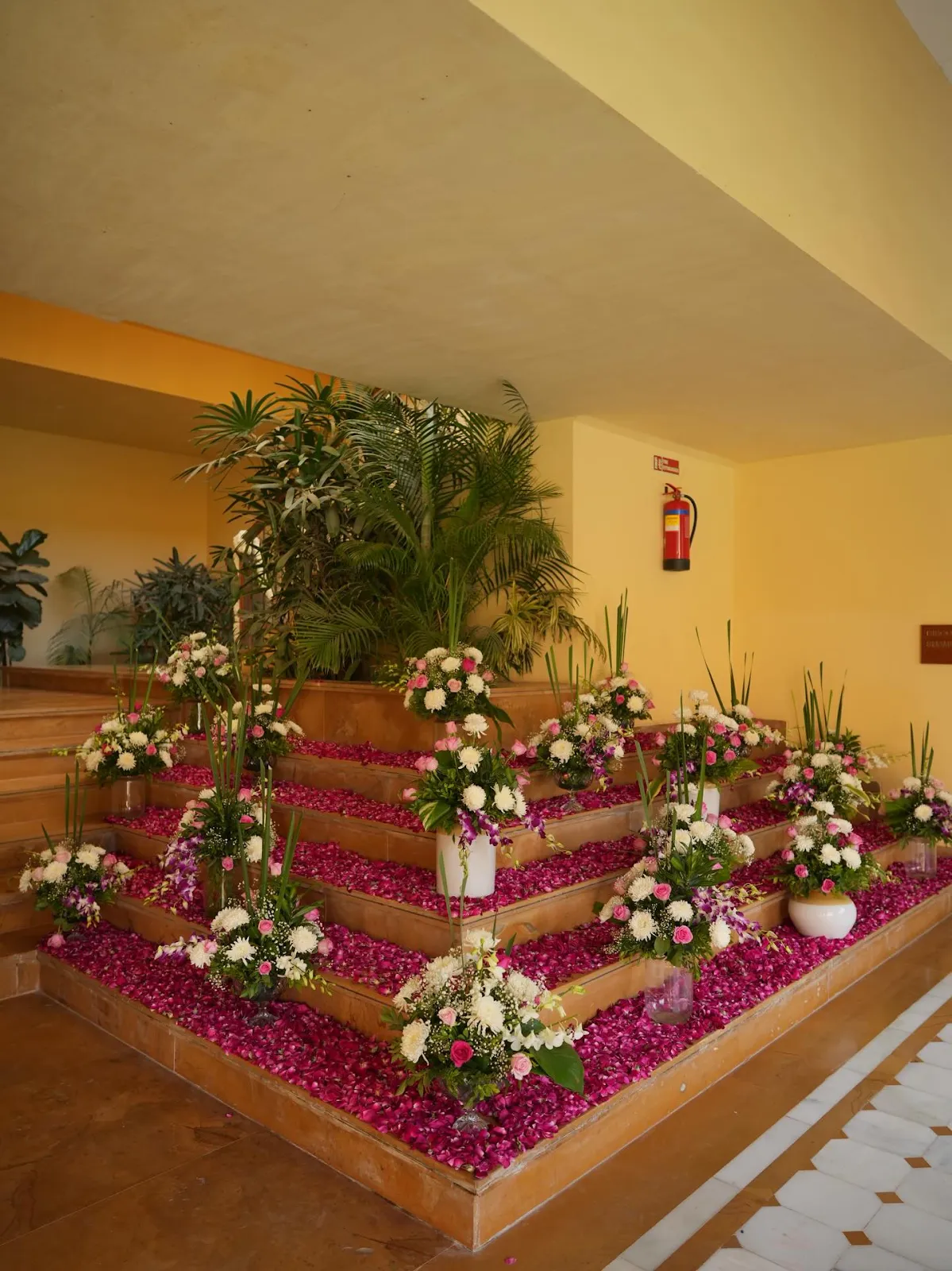 Tiered floral installation with rose petal carpets