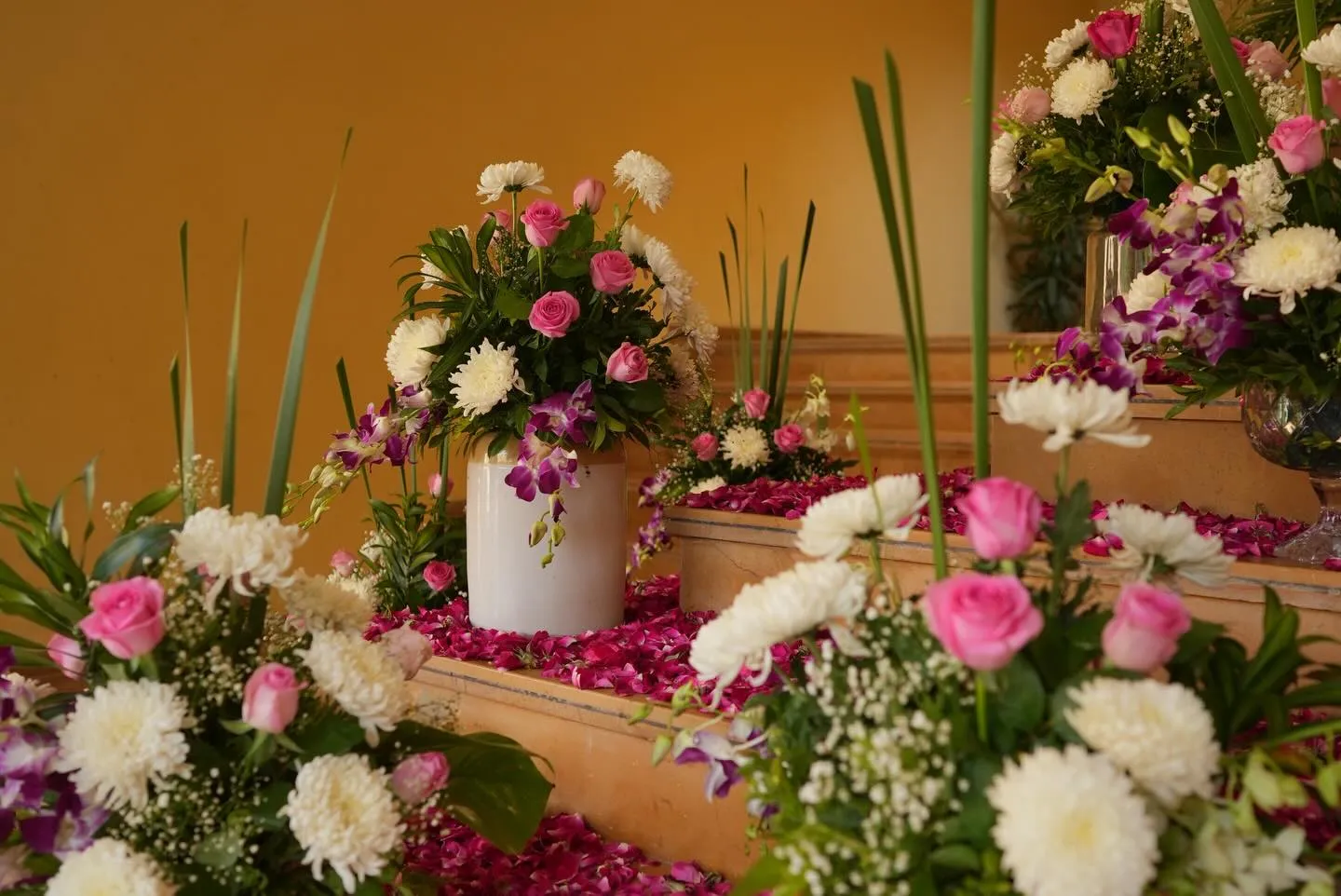 Floral urns of roses, orchids and chrysanthemums