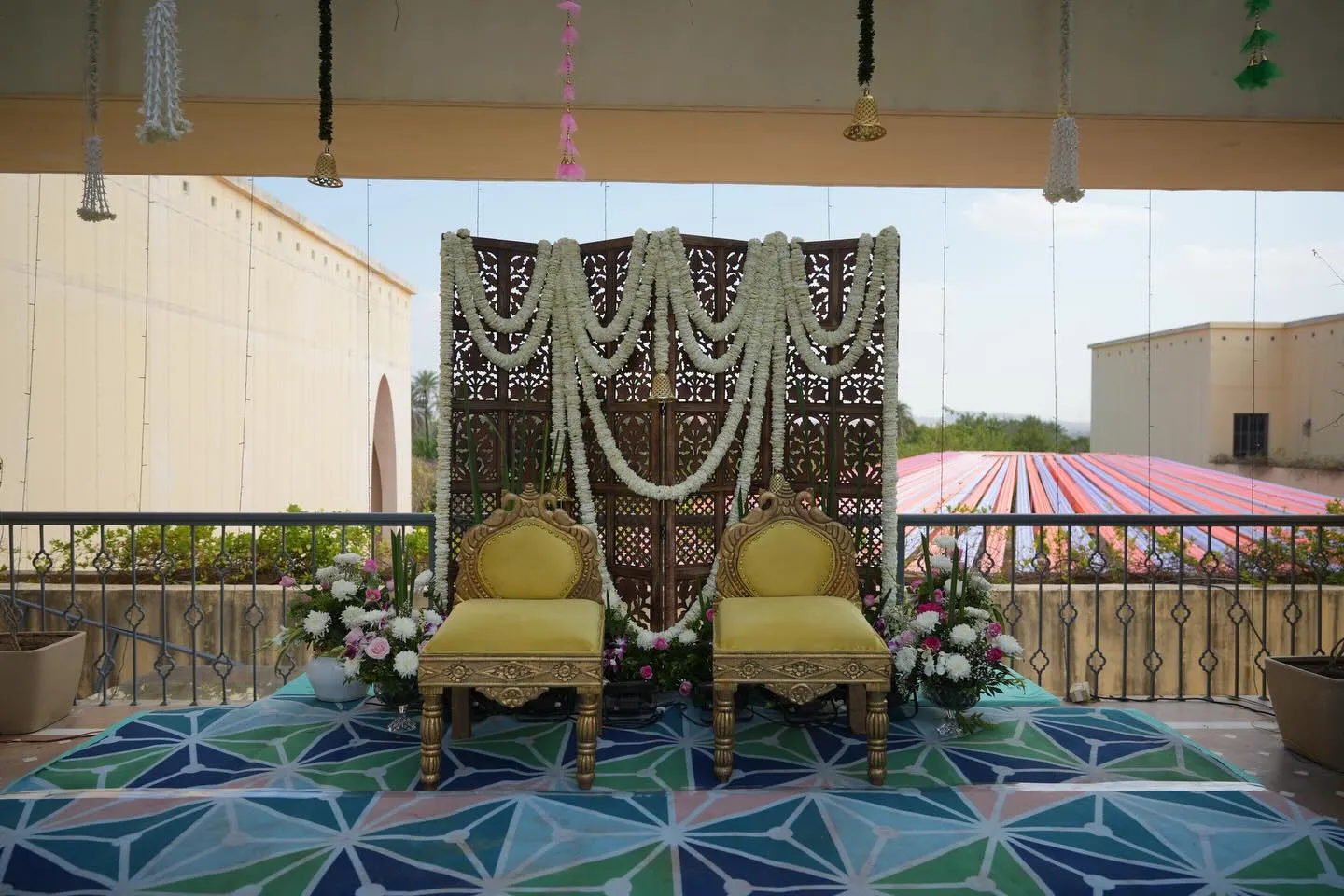Royal mandap stage with jaali backdrop and floral garlands