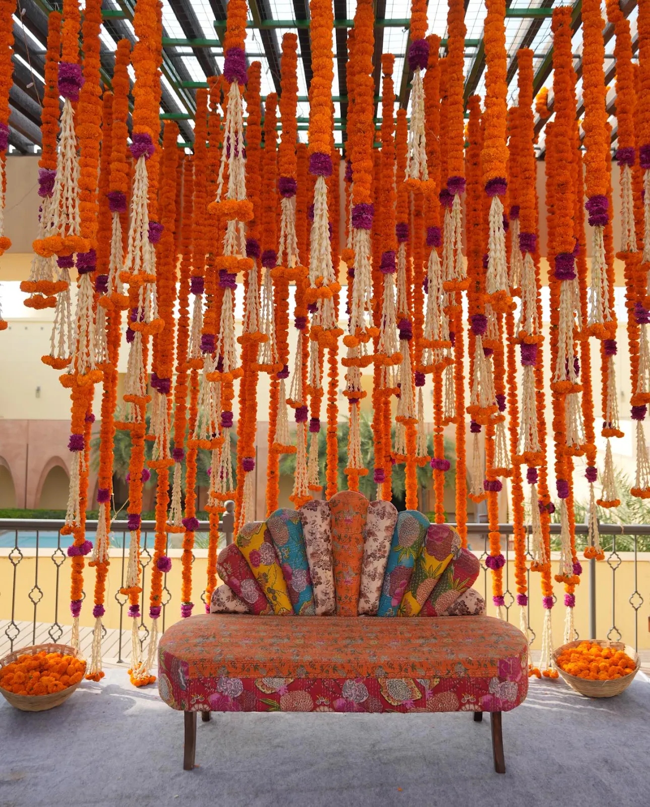 Marigold curtain haldi backdrop with a patterned divan
